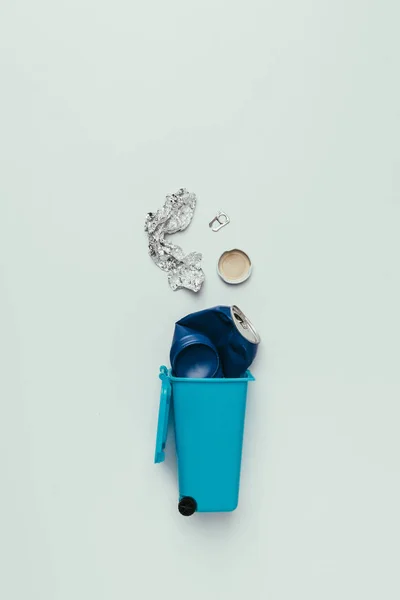 Top view of trash bin with assorted garbage isolated on grey, recycling concept — Stock Photo