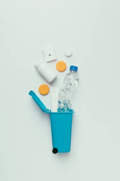 Top view of trash bin with plastic garbage isolated on grey, recycling concept — Stock Photo