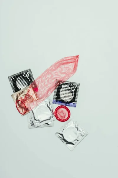 Top view of arrangement of condoms isolated on grey, safety concept — Stock Photo