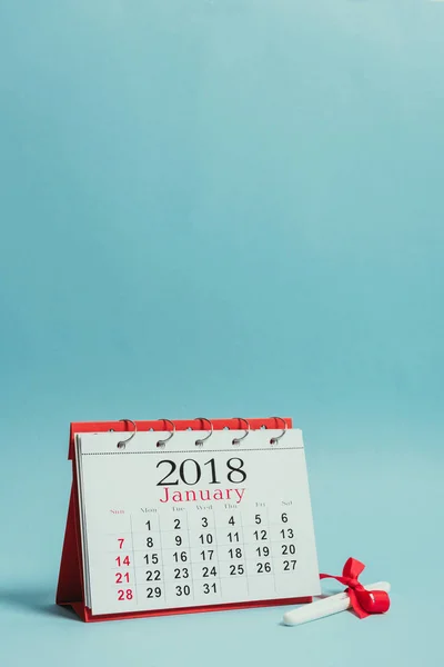 Close up view of calendar and pregnancy test with ribbon isolated on blue — Stock Photo