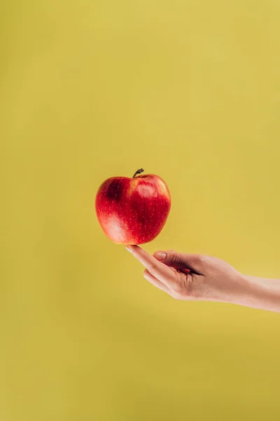 Partial view of woman holding apple on finger — Stock Photo