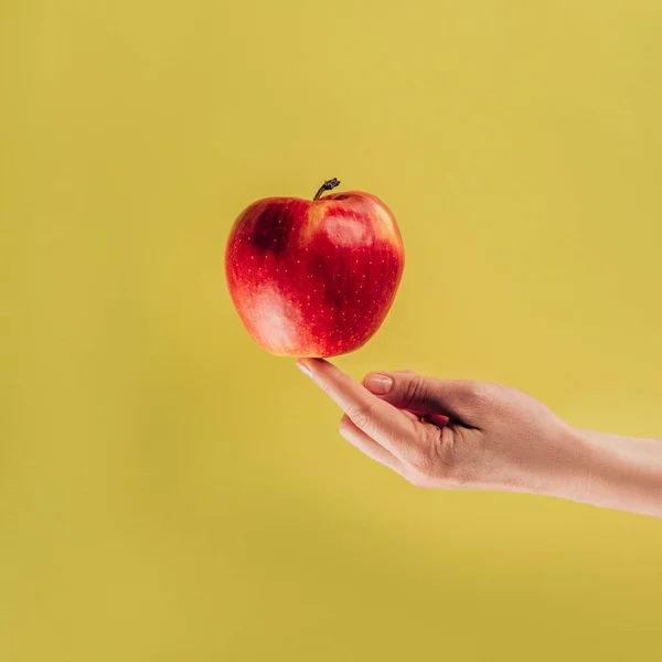 Partial view of woman holding apple on finger — Stock Photo