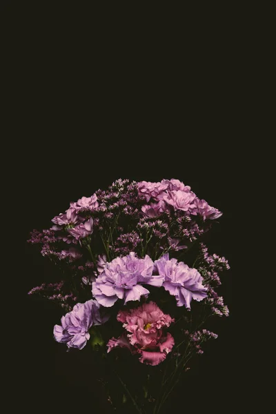 Close-up view of beautiful floral bouquet of pink and purple blooming flowers isolated on black — Stock Photo