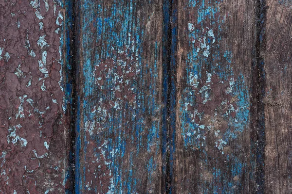 Старі тріщини фарби на фоні дерев'яної поверхні — стокове фото
