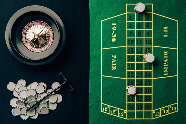 Gambling concept with chips and roulette on casino table — Stock Photo