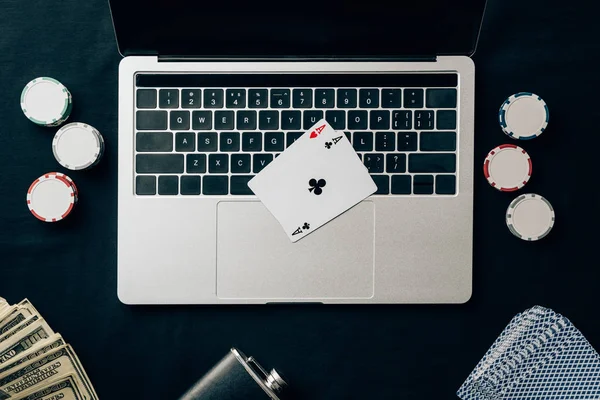 Online gambling concept with chips and money on laptop — Stock Photo