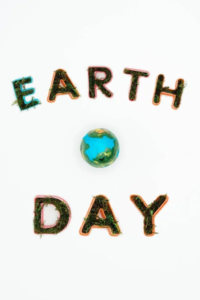 Top view of earth model with text earth day isolated on white — Stock Photo