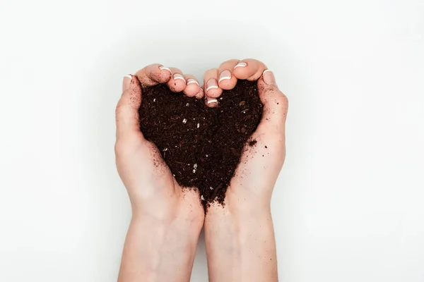 Cropped image of woman holding heart shaped soil in hands isolated on white, earth day concept — Stock Photo