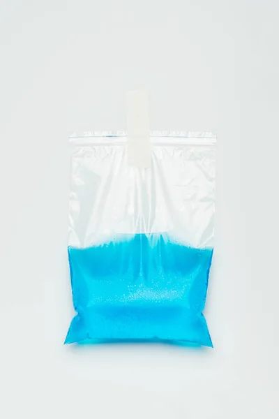 Plastic bag with blue water hanging isolated on white, earth day concept — Stock Photo
