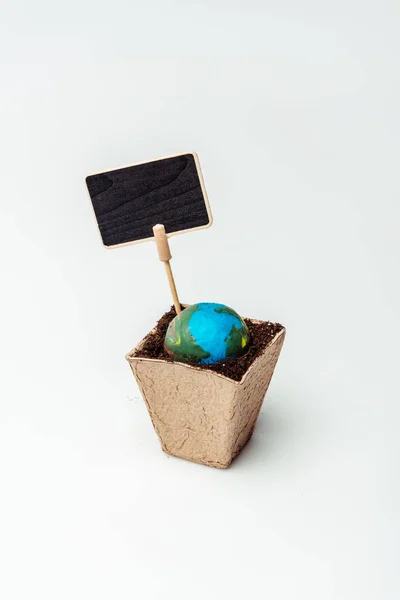 Earth model in flower pot with soil and blackboard isolated on white, earth day concept — Stock Photo