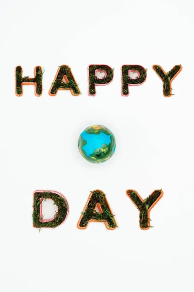 Top view of earth model with text happy earth day isolated on white — Stock Photo