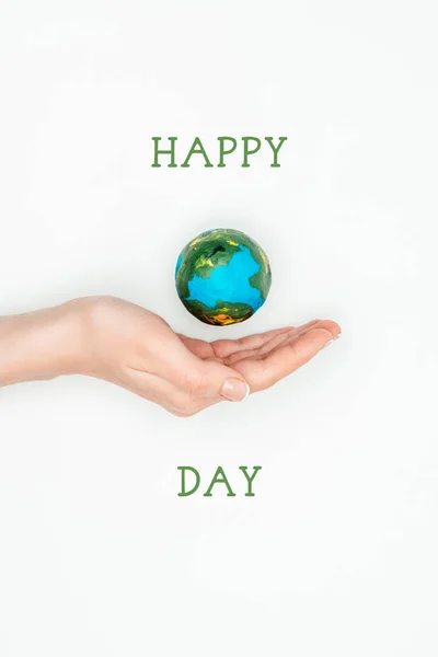 Cropped image of woman holding earth model on hand with sign happy earth day isolated on white — Stock Photo