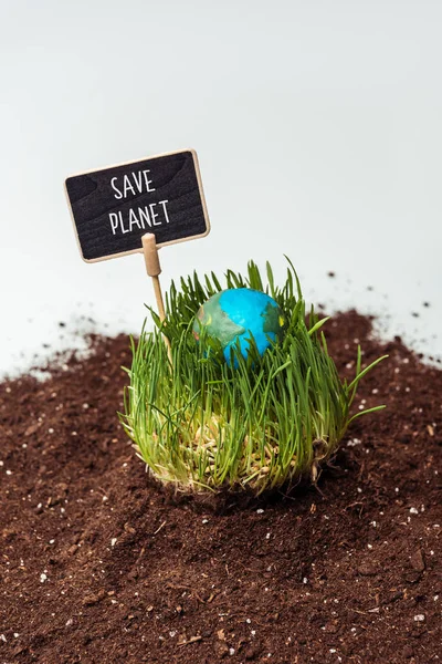 Seedling with earth model and sign save planet on soil isolated on white, earth day concept — Stock Photo