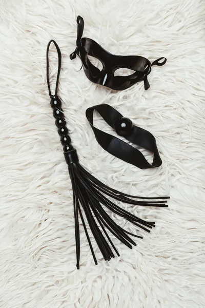 Black leather whip and ball gag with mask — Stock Photo