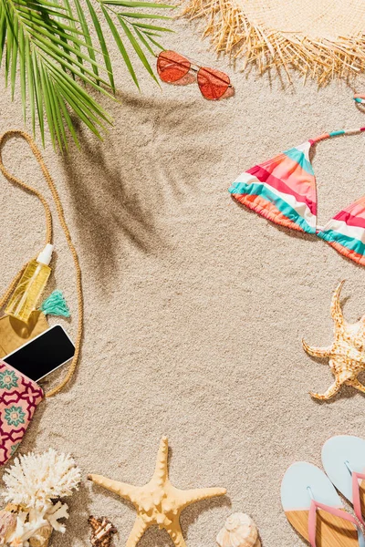 Top view of female accessories lying on sandy beach — Stock Photo