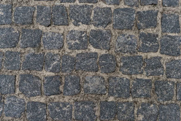 Straßenbelag aus schmutzigen Kieselsteinen — Stockfoto