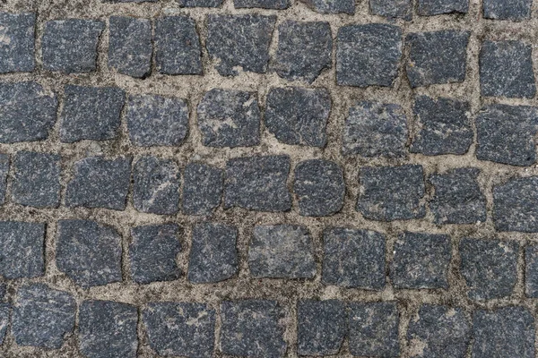 Dirty pebble stones road surface — Stock Photo