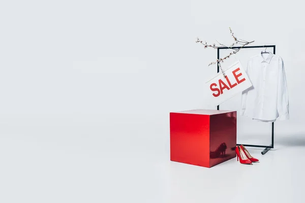 Red cube, shirt on hanger and sale sign, summer sale concept — Stock Photo