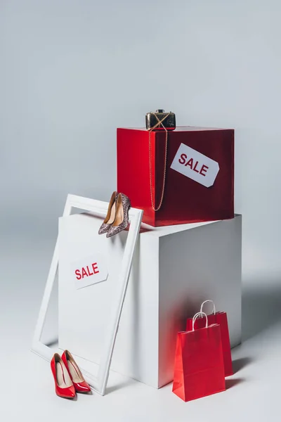 Red shopping bags, high heels and sale signs, summer sale concept — Stock Photo