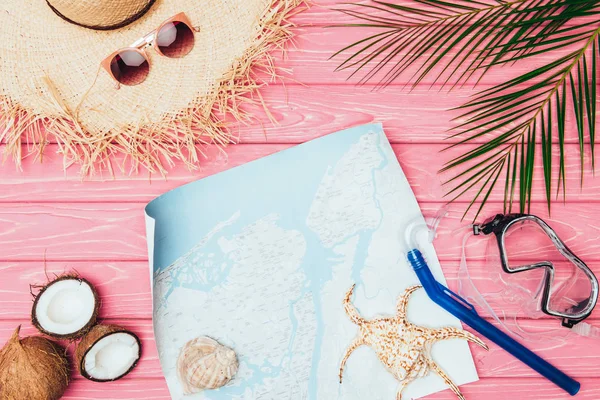 Top view of map with diving mask and snorkel on pink wooden surface — Stock Photo