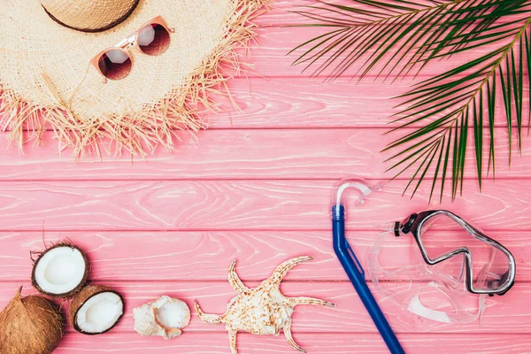 Top view of different travel attributes on pink wooden surface — Stock Photo