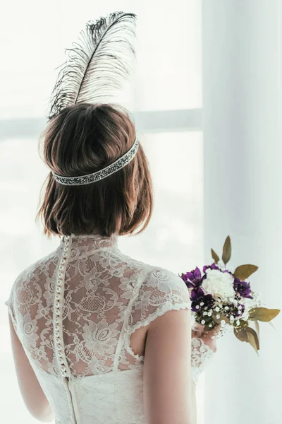 Back view of bride in white dress with beautiful bridal bouquet, rustic wedding concept — Stock Photo