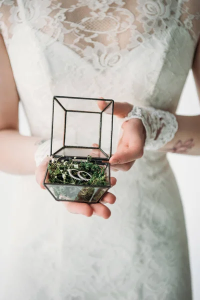 Cropped shot of bride in white dress with wedding rings in box in hands — Stock Photo