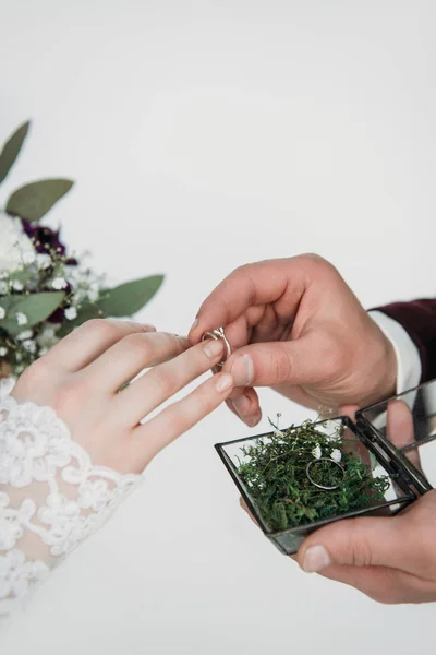 Partial view of groom wearing wedding ring on bridal finger — Stock Photo