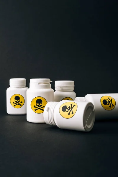 Bottles with toxic symbol isolated on black — Stock Photo