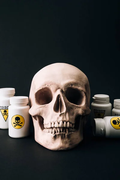 Skull and jars with poison sign isolated on black — Stock Photo