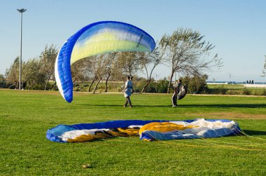 Samsun, Turkey - November 19, 2016: Paragliding course lessons for new beginners on the park clipart