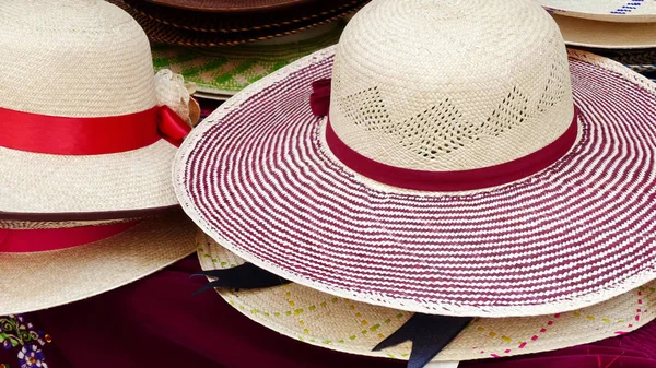 Colorful Handmade Panama Hats or Paja Toquilla hats or sombrero at the traditional outdoor market in Cuenca, Ecuador. Popular souvenir from South America