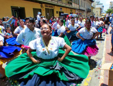 Cuenca, Ekvador - 2 Mart 2019: Karnaval sırasında geçit töreni. Azuay ili (cuancanos) kostümlü halk dansçıları Cuenca şehrinin tarihi merkezinde bulunmaktadır. Herkesin üzerine köpük püskürtülür.