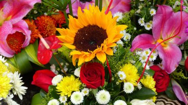 Bir buket rengarenk taze çiçek. Güller, zambaklar, ayçiçekleri. Yakın plan.
