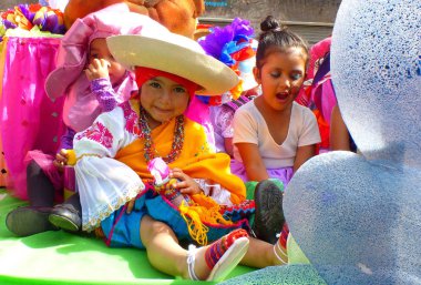 Cuenca, Ekvador - 27 Şubat 2019 Cuenca 'daki çocuklar için karnaval geçidi. Geleneksel elbiseli kızda geleneksel olarak karnaval sırasında sprey köpük püskürten bir kutu var.