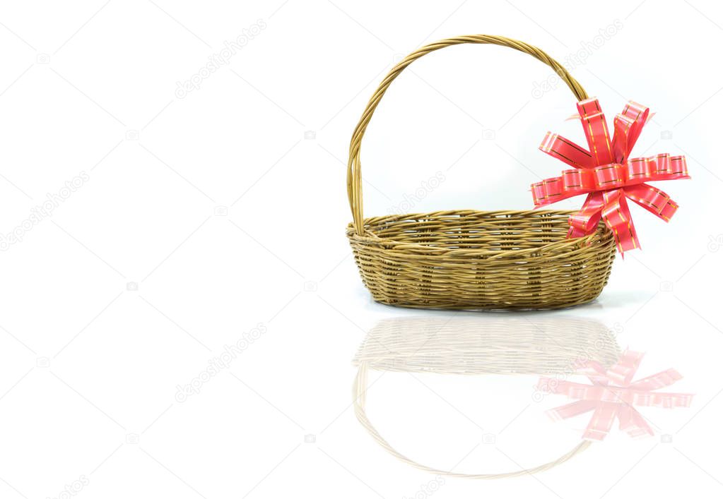 Empty wicker basket with red and gold ribbon isolated on white