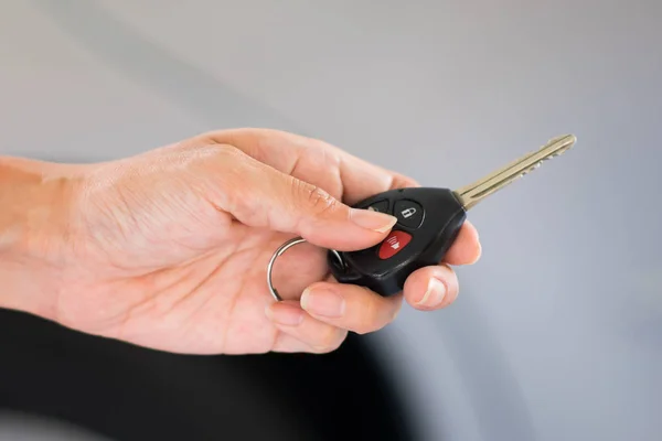 Woman's hand holding modern car keys ready for rental - Concept — Stock Photo, Image