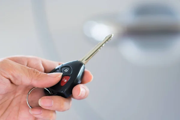 Woman's hand holding modern car keys ready for rental - Concept — Stock Photo, Image