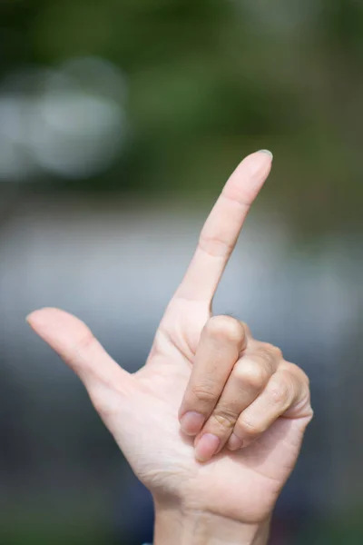 Woman pointing finger up to the sky.