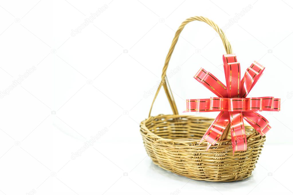 Empty wicker basket with red and gold ribbon isolated 