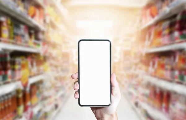 Usando smartphone para compras on-line no bac supermercado abstrato — Fotografia de Stock