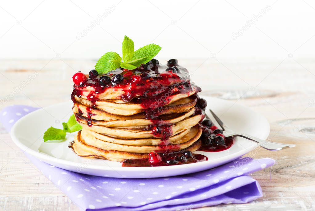 Stack of pancakes topped with berry jam