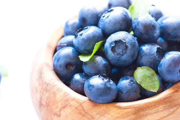 Fresh blueberriaes in wooden bowl. — Stock Photo, Image