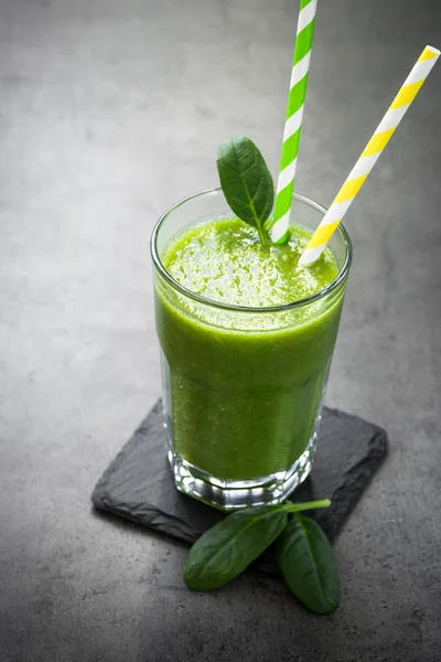 Healthy green spinach smoothie in glass