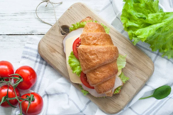 Sandwich de croissant con tocino, queso, lechuga y tomate — Foto de Stock