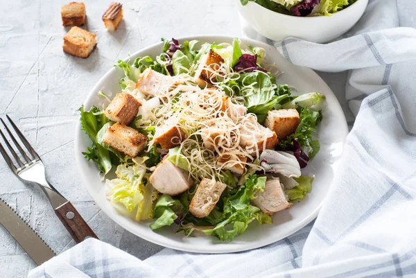 Caesar salad in white plate — Stock Photo, Image