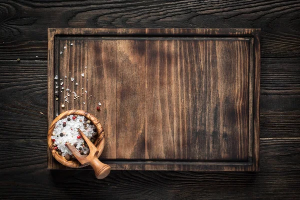 Cutting board on dark wooden table. Stock Photo by ©Nadianb 150103562