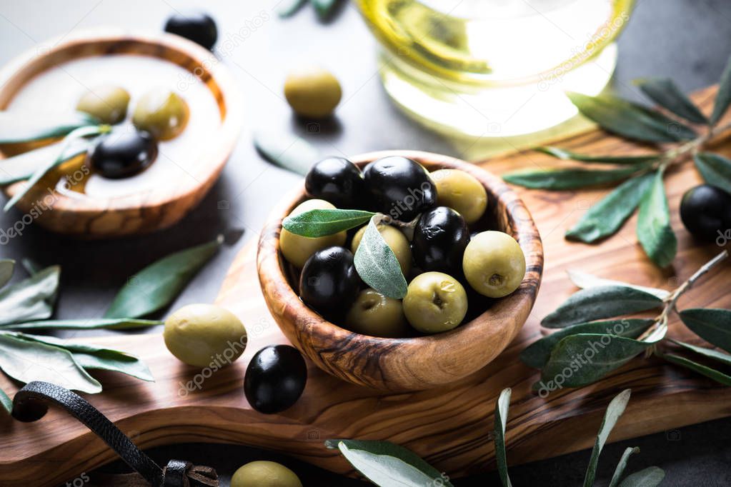 Black and green olives and olive oil.