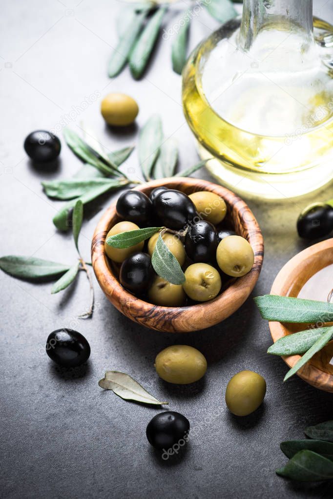 Black and green olives and olive oil.