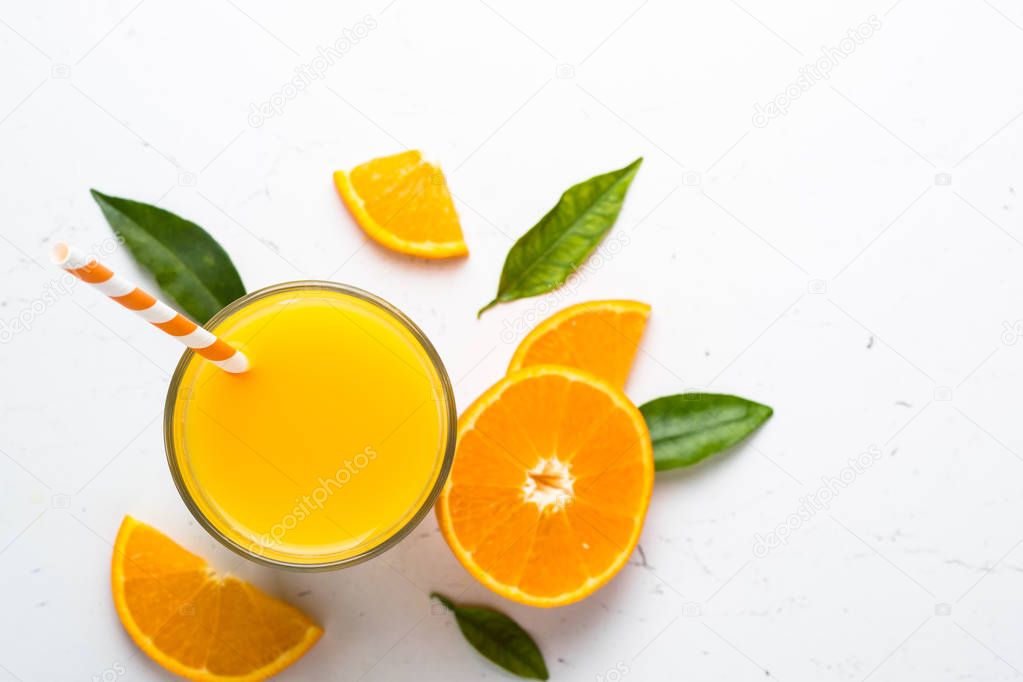 Orange juice in glass on white.